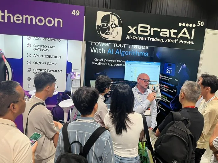 Traders gathered around the xBratAI booth at a Hong Kong trading expo